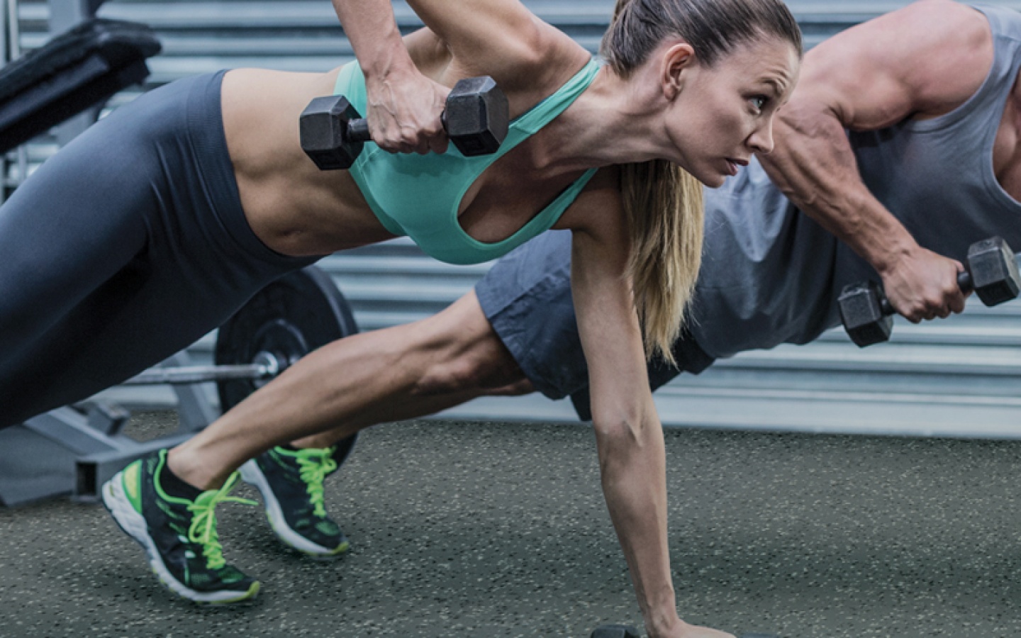 Woman and Man Working Out On Synthetic Gym Floor